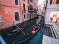 Venice, Italy - 17.10.2023: Gondolas with tourists passing slowly in a small channel between stunning old buildings of the city. Royalty Free Stock Photo