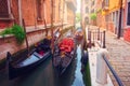 Venice, Italy. Gondolas in Venetian narrow water channel along houses