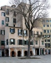 Venice, Italy. Buildings and tree in Campo del Ghetto Nuovo, central square in Jewish Ghetto. Royalty Free Stock Photo