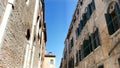 VENICE, ITALY - JULY 7, 2018: beautiful old architecture of Venice, a house with old green shutters and flowers on the Royalty Free Stock Photo