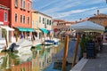 Old houses, a restaurant and canals on the island of Murano near Venice