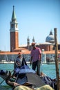 VENICE, ITALY - JULY 12 : Gondolier plying his tradein Venice Italy.