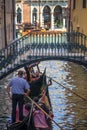 VENICE, ITALY - JULY 12 : Gondolier plying his tradein Venice It