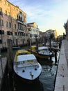 A row of Venetian water ambulance boats docked along a canal outside the hospital in Venice, Italy on a quiet summer morning