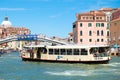 Vaporetto sails below the Ponte degli Scalzi on the Grand Canal in Venice