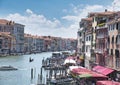 Venice, Italy - July 1, 2017: A view of the colorful Venetian houses, Gondolas and boats docked along the grand canal in Royalty Free Stock Photo