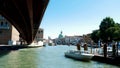 VENICE, ITALY - JULY 7, 2018: views of Venice, grand canal, under the bridge small boats, gondolas sail, on a hot summer