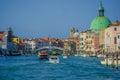 VENICE, ITALY - JUNE 18, 2015: Colored city, unique and special Venice. Boats on the sea, green dome in the corner