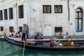 Venice, Italy - 30 June 2018: Gondolier taking tourists on a Gondola ride along the grand canal near Fondamenta de la preson in Royalty Free Stock Photo