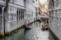 Venice, Italy - June 27, 2014: Tourists sailing on gondolas on water canal under Bridge of Sighs Royalty Free Stock Photo