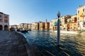 Grand canal, gondolas and pleasure boat. Campanile of Church of Santi Apostoli Royalty Free Stock Photo