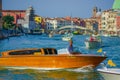 VENICE, ITALY - JUNE 18, 2015: Unidentified boat driver, Venice taxi. Wood boat in the middle of the water