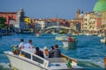 VENICE, ITALY - JUNE 18, 2015: Unidentified tourists taking taxi on Venice, water transportation is very common in Italy