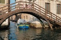 Venice, Italy, A laden barge sails along a channel under a bridge