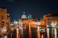 Venice, Italy. Majestic Basilica di Santa Maria della Salute at night. Grand Canal light reflected on water surface. Royalty Free Stock Photo