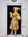 Venice, Italy - March 1, 2019 A person dressed with a gold Arlequin costume Royalty Free Stock Photo