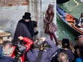 Venice, Italy - March 2, 2019 Photographers gathers around a couple dressed with Venetian costumes