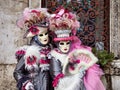 Venice, Italy - March 1, 2019 Two person dressed with typical Venice Costumes pose for a photo Royalty Free Stock Photo