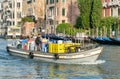 Boat on Grand canal delivering goods merch for stores in Venice