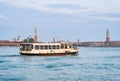 Crowded public venetian public waterbus called vaporetto (ACTV) on Grand Canal in Venice