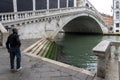 Venice, Italy-May 10, 2020:Elderly man in protective medical mask on the Rialto bridge in Venice. Coronavirus elderly advice. Royalty Free Stock Photo