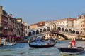 Venice, Italy - May 2019: Gondolas and boats on Grand canal with Rialto bridge at background Royalty Free Stock Photo