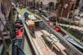 Goods and materials transported and delivered by boat in narrow canals with gondola and tourists