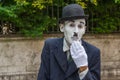 VENICE, ITALY - May 24, 2016: Male mime looking like a Charlie Chaplin in Venice with white glove and dark hat. Street male mime