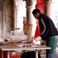 Man cleans the fish at the Venice market