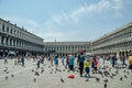 Venice, Italy May 18, 2015: People enjoying the view of massive Saint Mark`s Square in Venice Italy