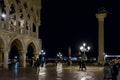 People walk on St Mark`s square in Venice city at night. San Marco is a main tourist attraction of Venice Royalty Free Stock Photo