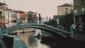 VENICE, ITALY - MAY 26, 2023. Small pedestrian bridge on the channel in the evening