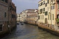 Traditional canal in Venice with motoboat crossing it Royalty Free Stock Photo
