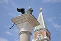 Two symbols of Venice: the Lion, the San Marco bell tower. Royalty Free Stock Photo