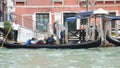 VENICE, ITALY - MAY 31, 2016: Unidentified Venetian gondolier paddled gondola through green Grand Canal in Venice, Italy