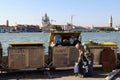VENICE, ITALY - MAY 17, 2012: Venice inhabitant throws out trash in dustbin Royalty Free Stock Photo