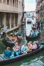 Venice, Italy - May 25, 2019: view of gondolas traffic in canal singer at boat