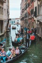 Venice, Italy - May 25, 2019: view of gondolas traffic in canal singer at boat