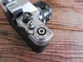 VENICE, ITALY - MAY 13, 2017: A Zenit EM is a vintage film camera made in URSS, lying over a dated wooden background Royalty Free Stock Photo