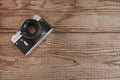 VENICE, ITALY - MAY 13, 2017: A Zenit EM is a vintage film camera made in URSS, lying over a dated wooden background Royalty Free Stock Photo