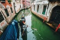 Venice Italy. Narrow canal with Gondola and old typical facade houses