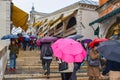 People walking with umbrellas on staircase of Rialto Bridge Ponte de Rialto in Venice, Italy Royalty Free Stock Photo