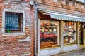 Storefront of brick wall Italian retail shop selling bags in Venice, Italy