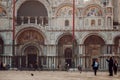 VENICE, ITALY - OCTOBER 6 , 2017: Basilica di San Marco, Tourists walk on square