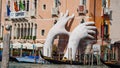 VENICE, ITALY - OCTOBER, 2017: Big Lorenzo Quinn hands support the city against climate change.