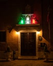 Entrance of an old house with colorful lights at night Royalty Free Stock Photo