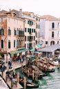 Venice, Italy - 04 october 2019: Gondola pier near the Rialto Bridge, Venice, Italy, Europe. Tourists walk on souvenir Royalty Free Stock Photo