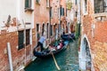 Gondolier on a gondola on canal street in Venice, Italy