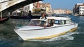 Motorboat Cruising down the Grand Canal in Venice on October 12, 2014. Unidentified people