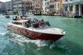 Motorboat Cruising down the Grand Canal in Venice on October 12, 2014. Unidentified people